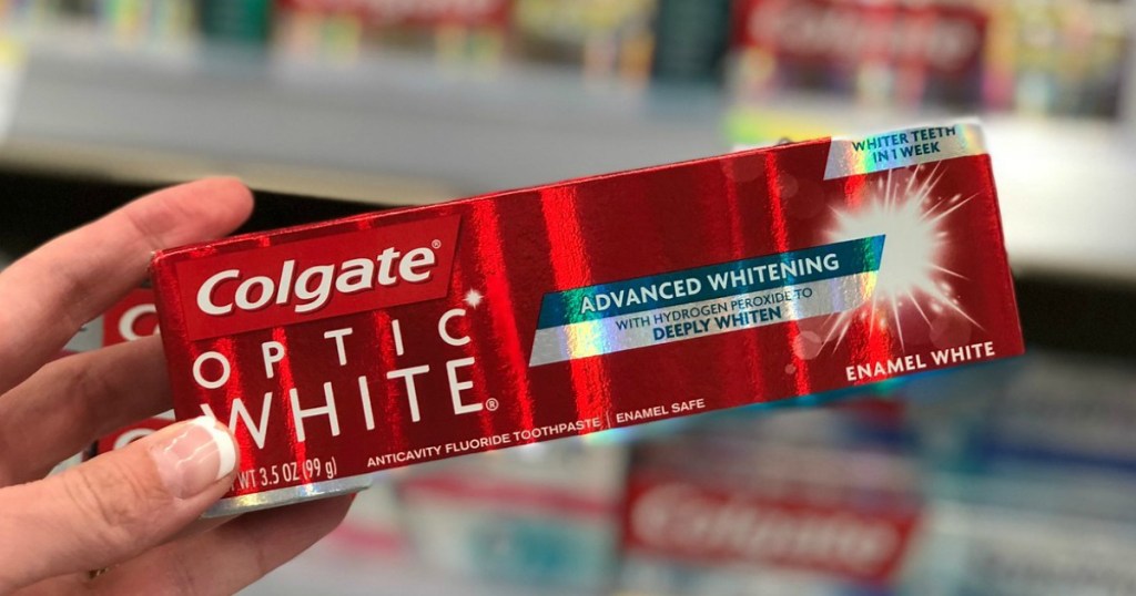 hand holding colgate optic white toothpaste at walgreens