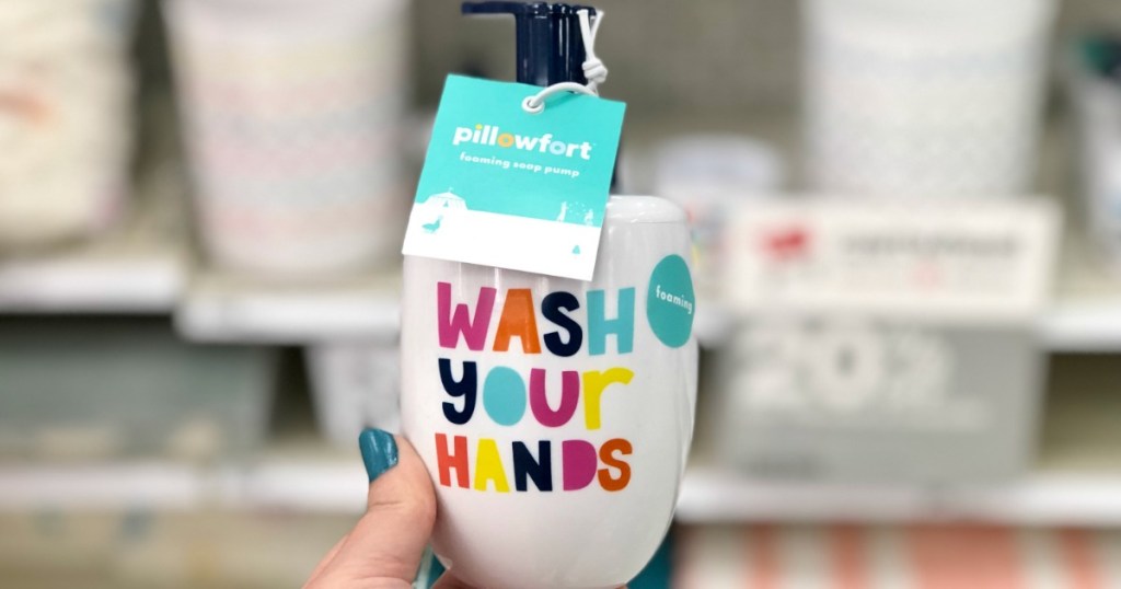 hand holding wash your hands soap dispenser with blurred background