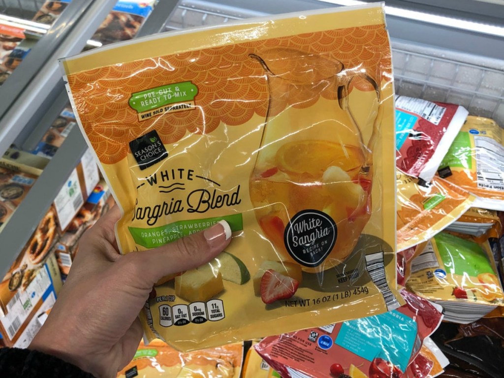 person holding a bag in the frozen department of a sangria blend