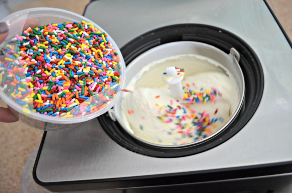 Adding sprinkles to homemade birthday cake ice cream batter that is in a whynter ice cream maker