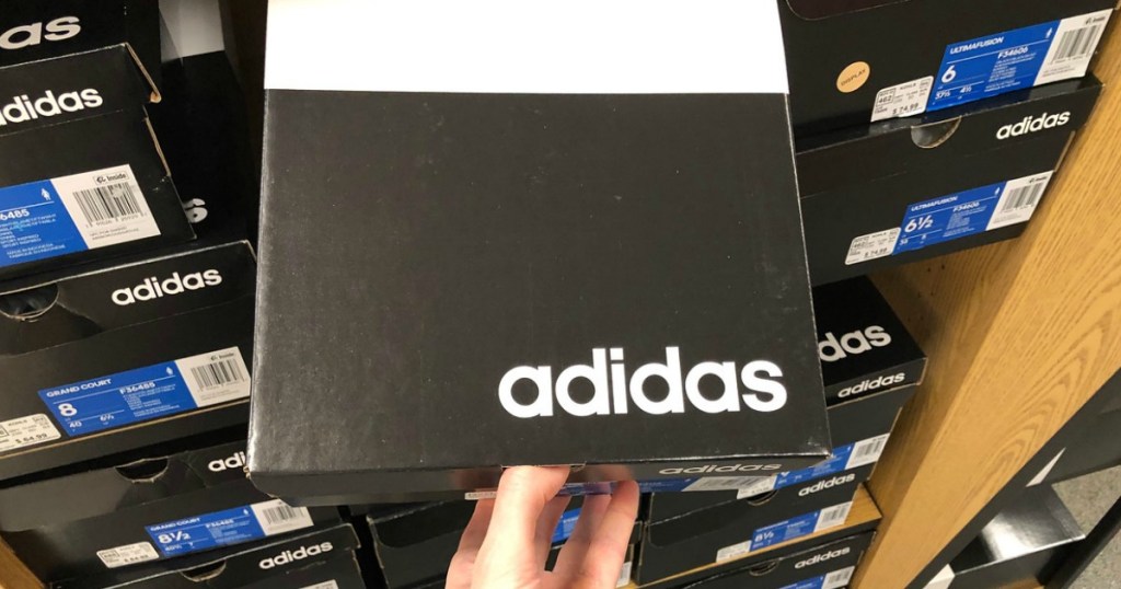 Box of Adidas brand shoes from shelf in-store