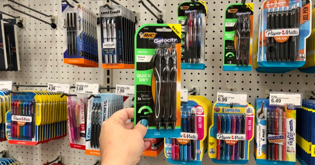 woman holding bic gel-ocity pens at store