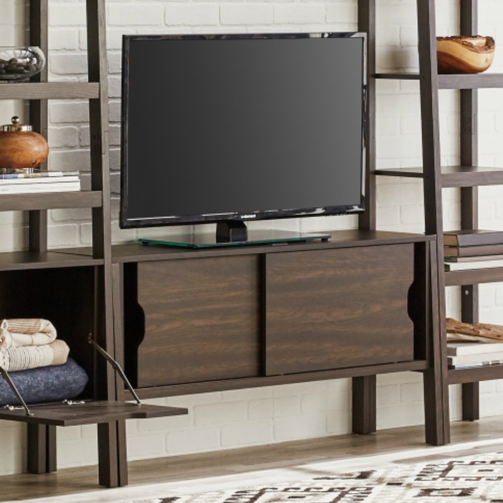 Dark colored sliding door TV stand from Better Homes and Gardens in living room set up with coordinating shelves