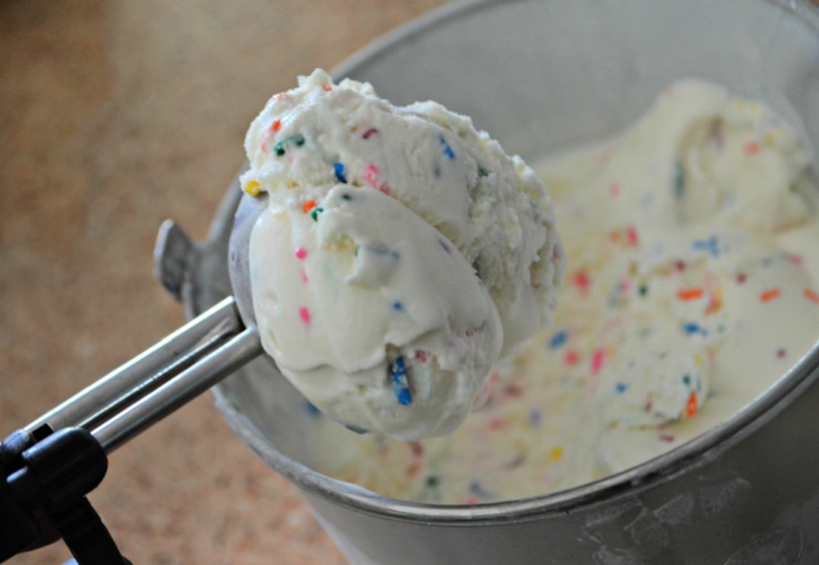 A scoop of homemade birthday cake ice cream that tastes like cake batter