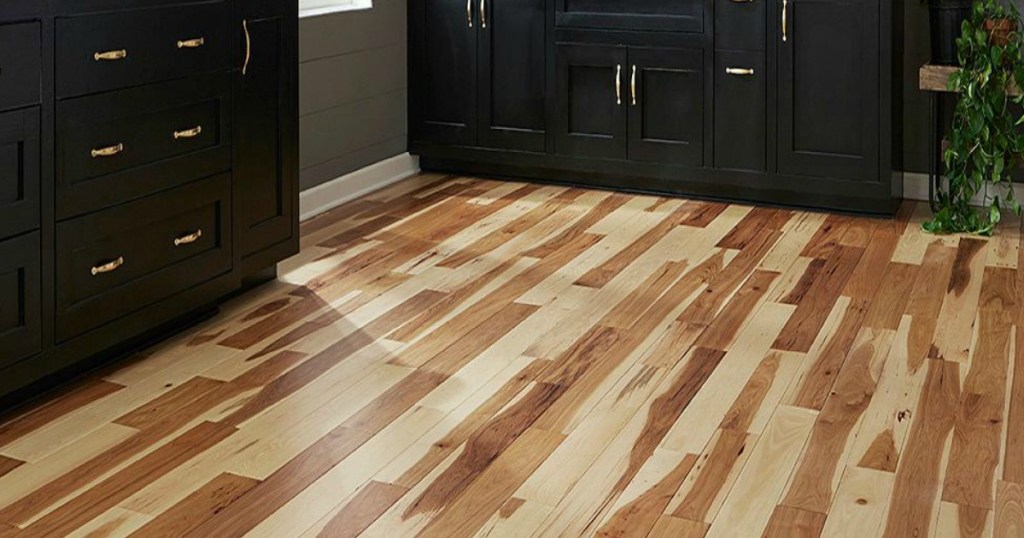 hard wood flooring in kitchen with black furniture on floor