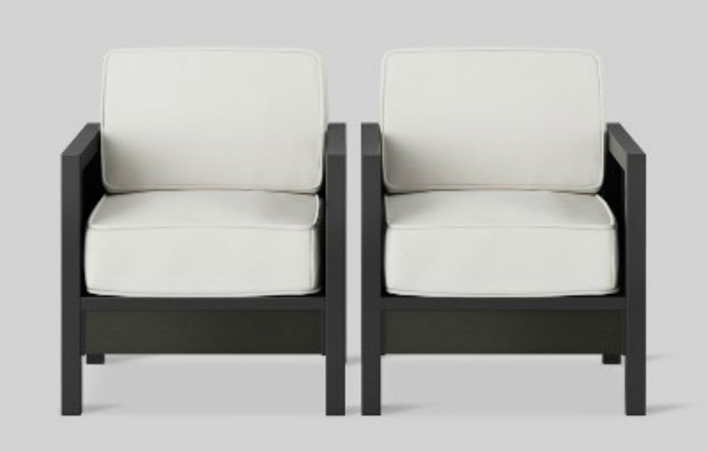 two patio club chairs with white cushions