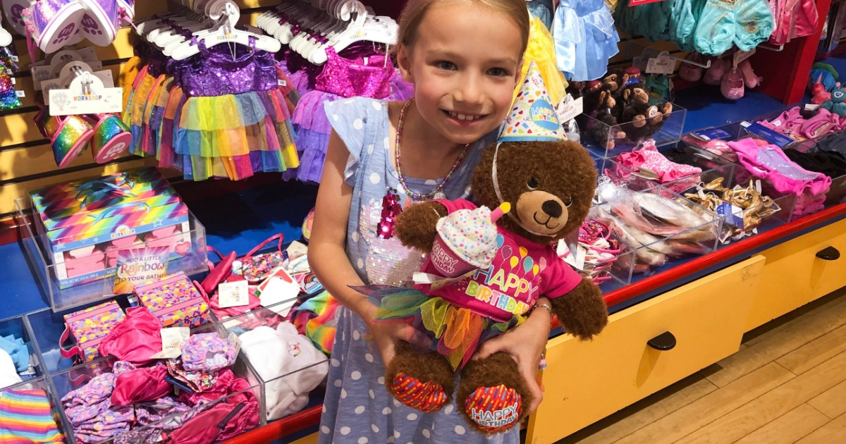 girl holding build-a-bear birthday bear