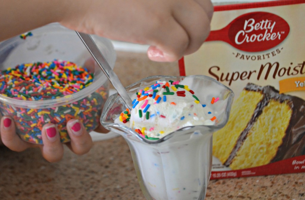 Placing sprinkles on cake batter ice cream