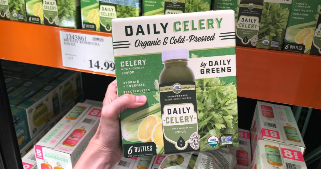 woman holding box of celery juice at costco