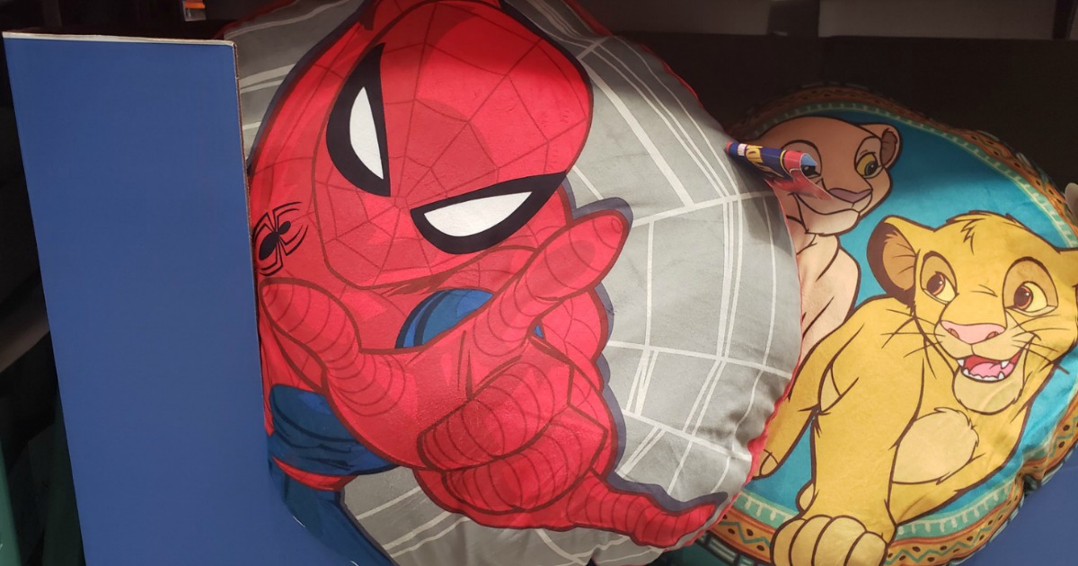 Spiderman and Lion King floor seating cushions in a store bin
