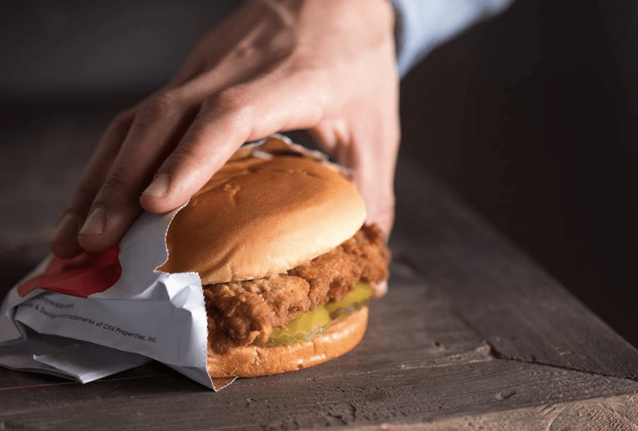 holding a Chick-fil-A sandwich