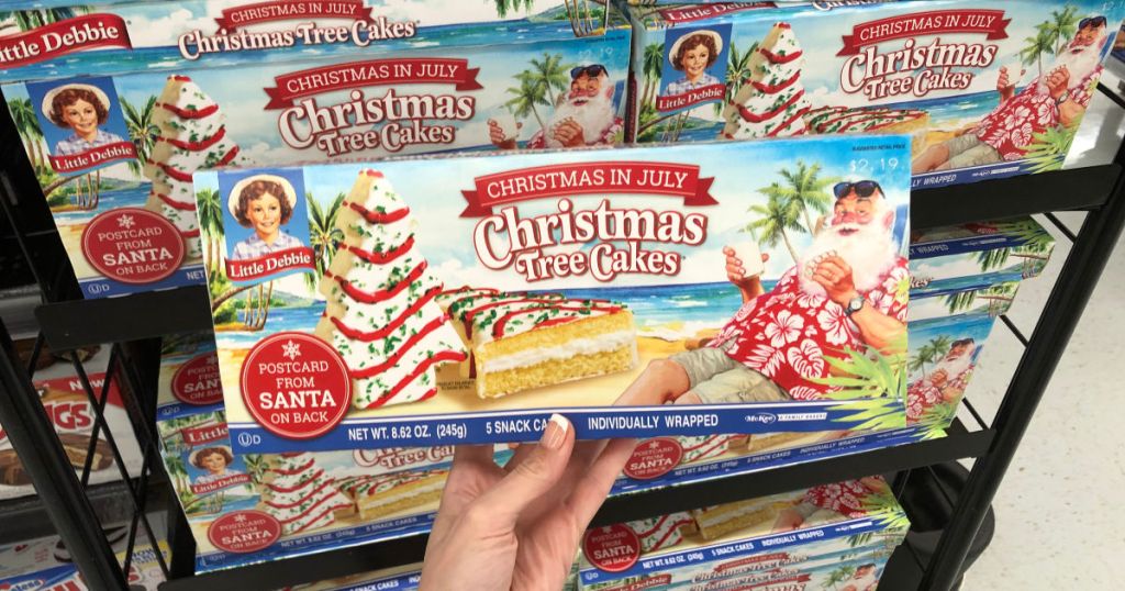 hand holding christmas in july little debbie christmas tree cakes