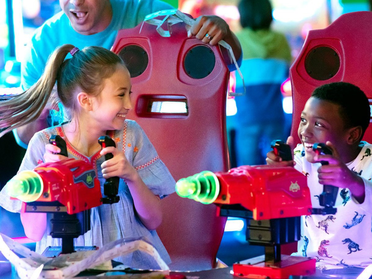 girl and boy playing a game at chuck e cheese