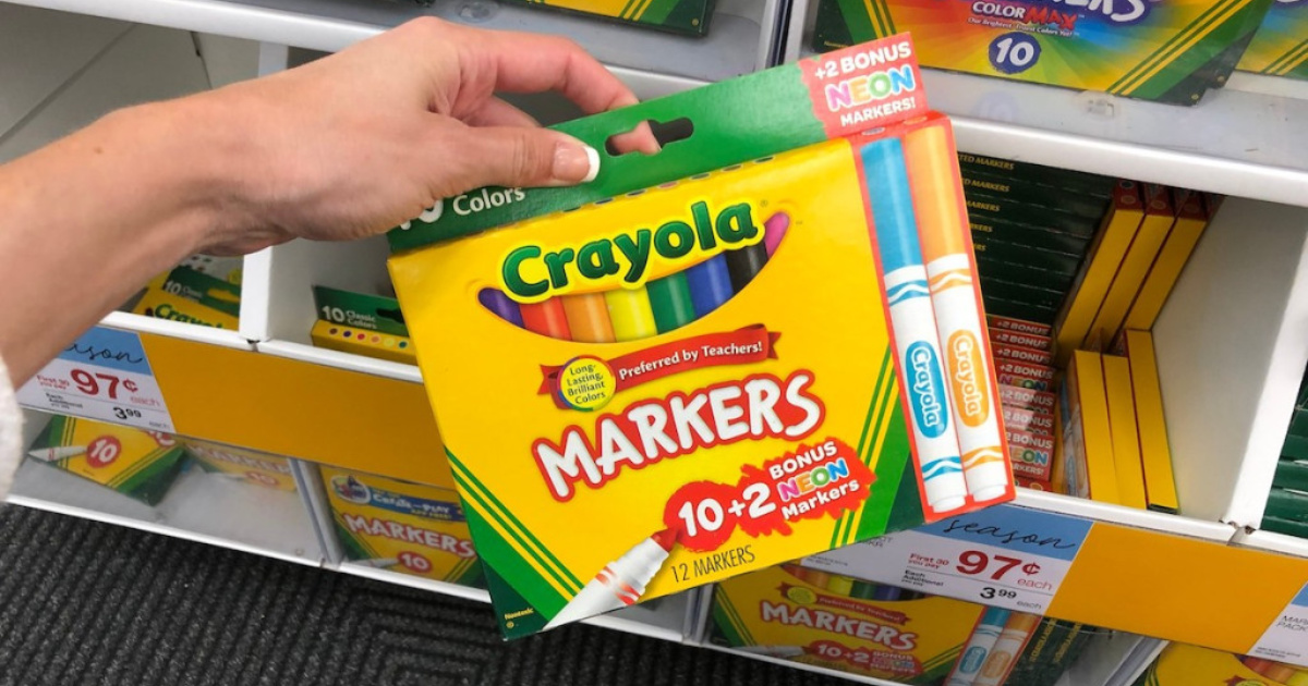 hand holding a 12-pack of Crayola markers in front of a store shelf