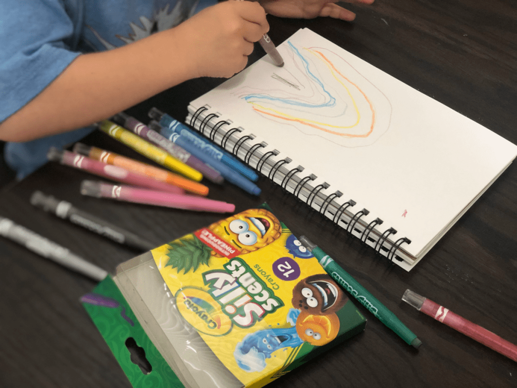 Crayola Silly Scents Twistable Crayons with child drawing