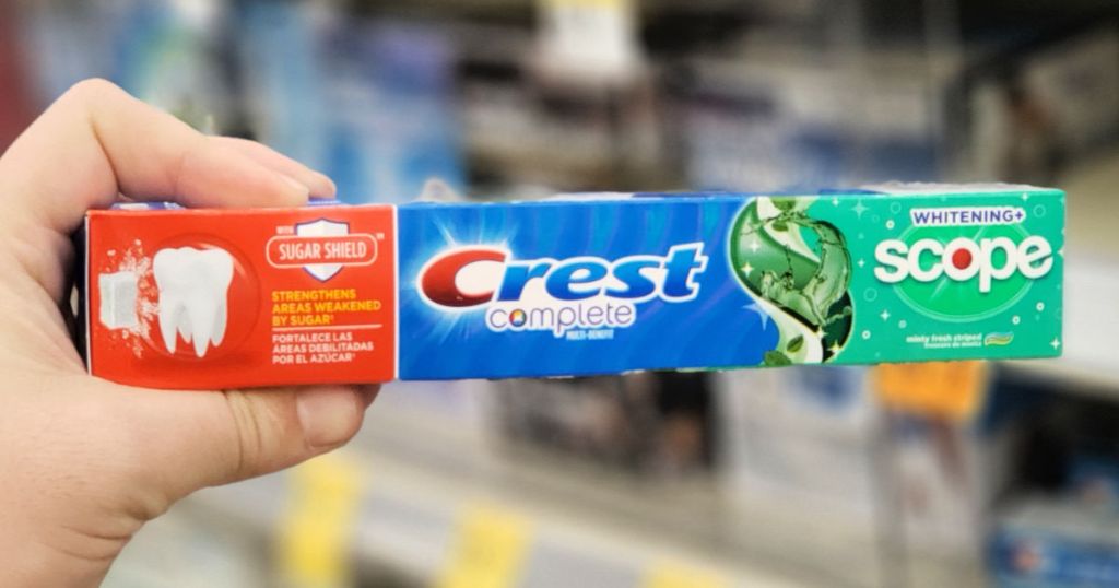 hand holding crest complete scope tooth paste