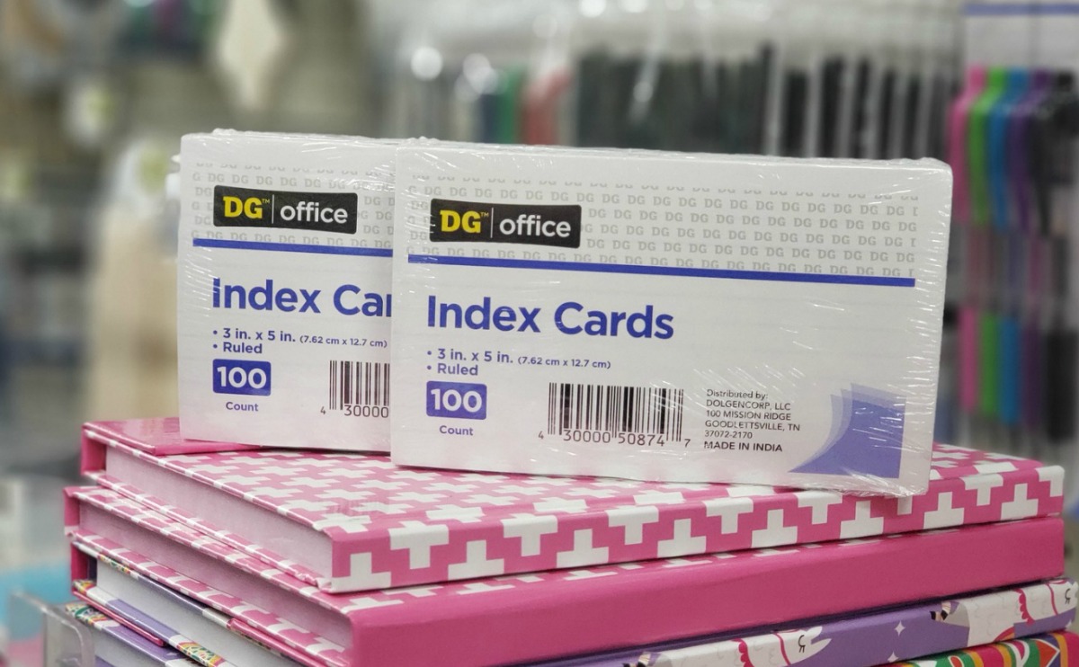 Two packs of index cards 100-count on top of a stack of journals in store