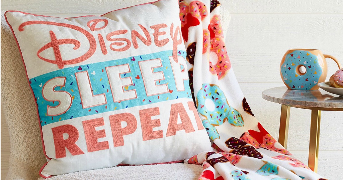 Disney Sleep Eat Repeat Pillow on chair with matching blanket on sale suring shopdisney friends and family sale