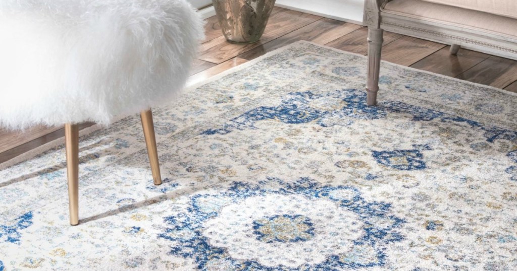 Distressed Persian Bosphorus 5' x 7'5" Area Rug with a white fluffy chair on it