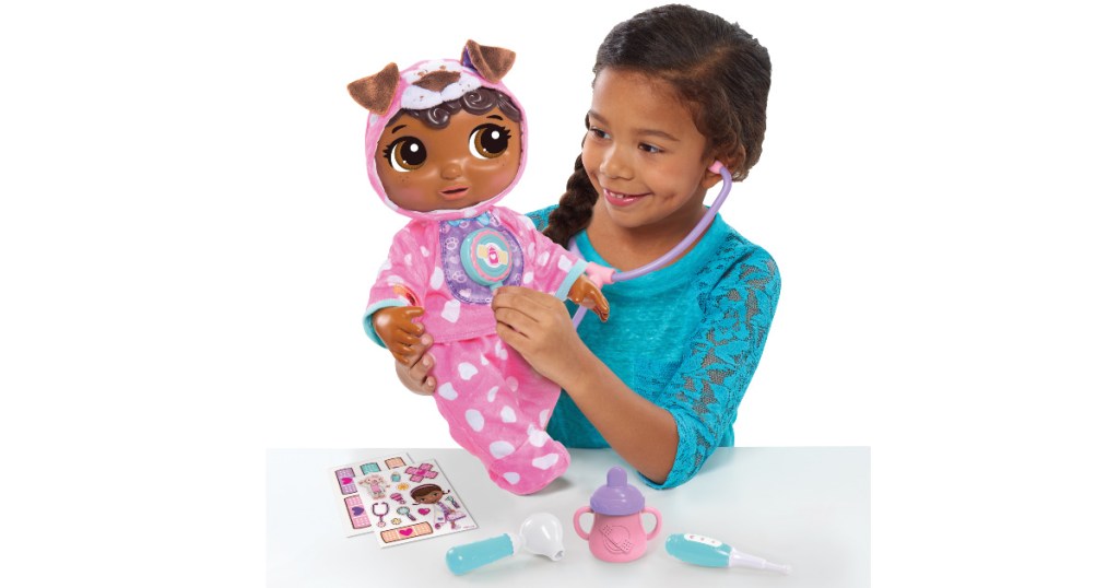 girl playing with doc mcstuffins doll