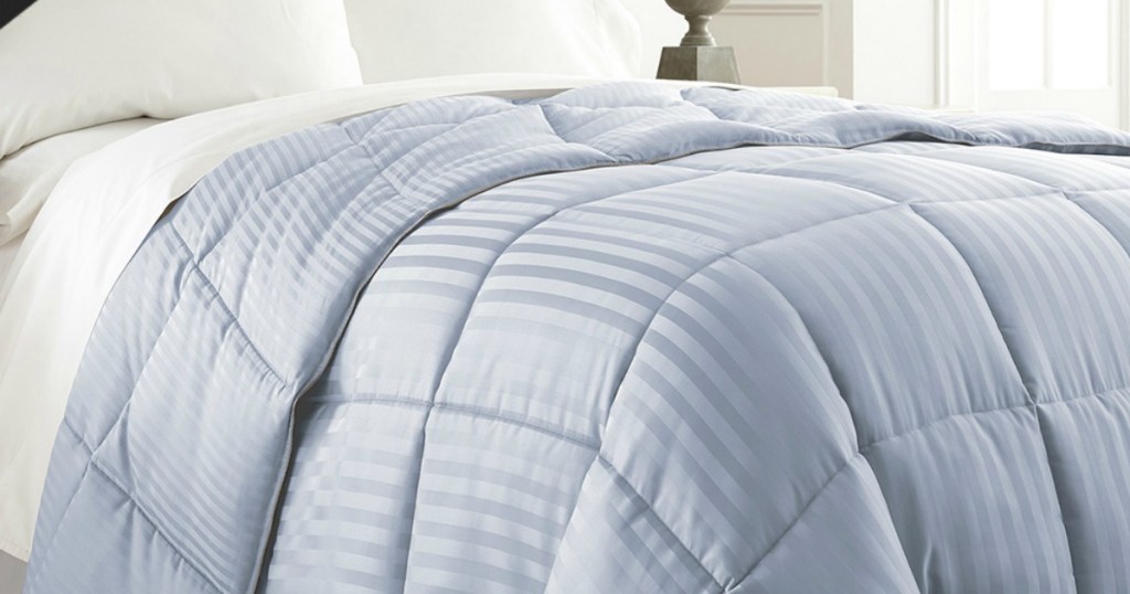 Blue striped down alternative comforter on bed