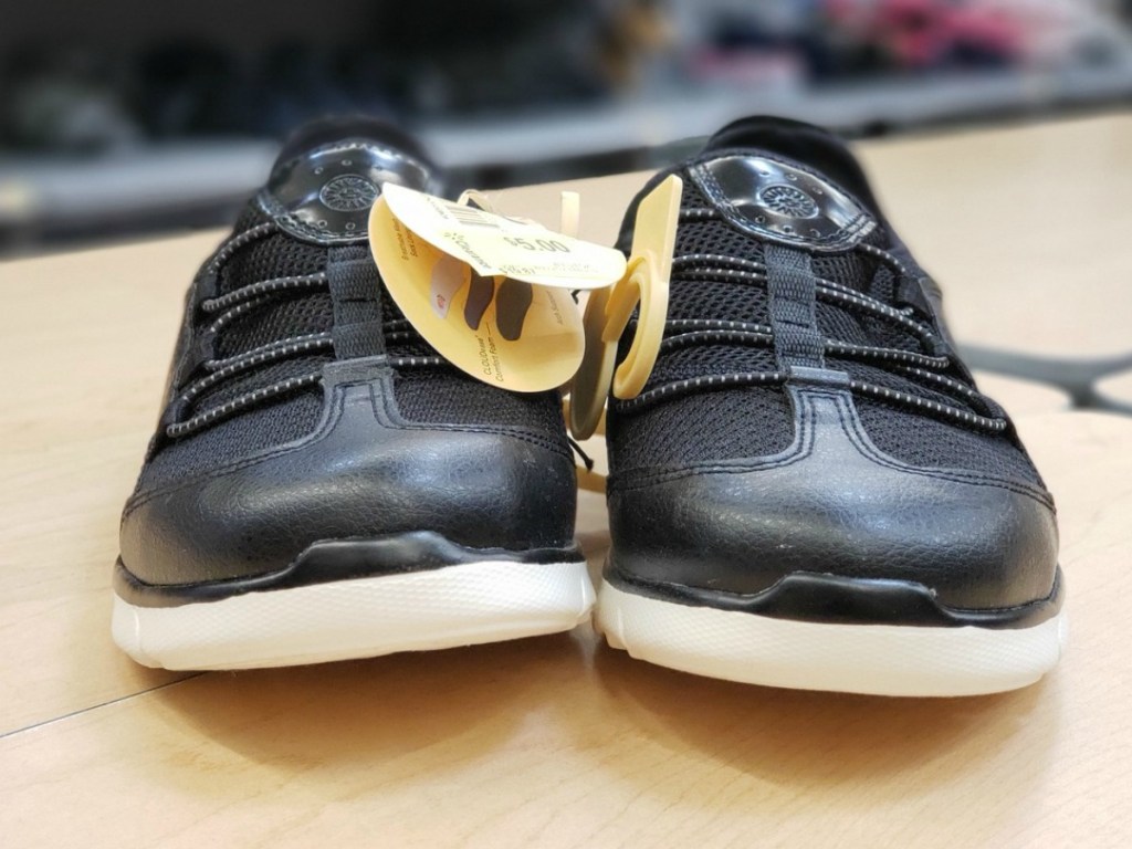 black pair of shoes with tags on a table