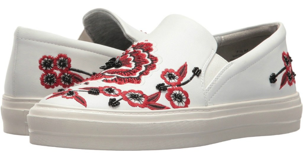 white canvas sneakers embroidered with red and black flowers