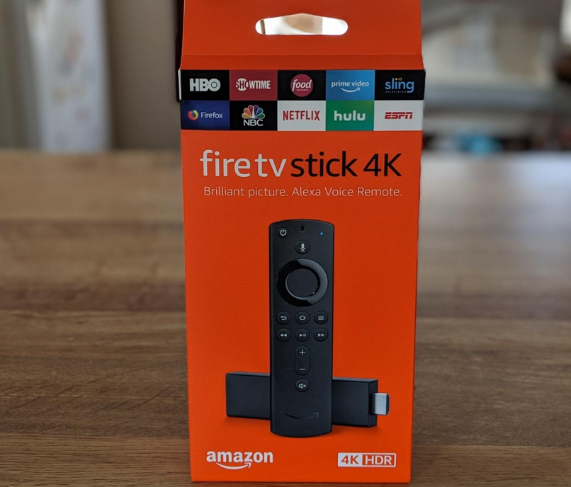 Fire TV Stick 4K with Alexa Voice Remote in box on table