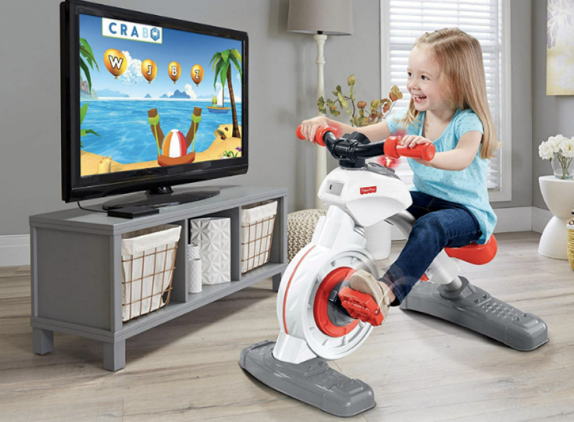 Toddler girl peddling Fisher-Price Think & Learn Smart Cycle