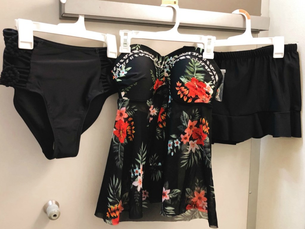 Black and floral tankini with bottoms hanging in dressing room
