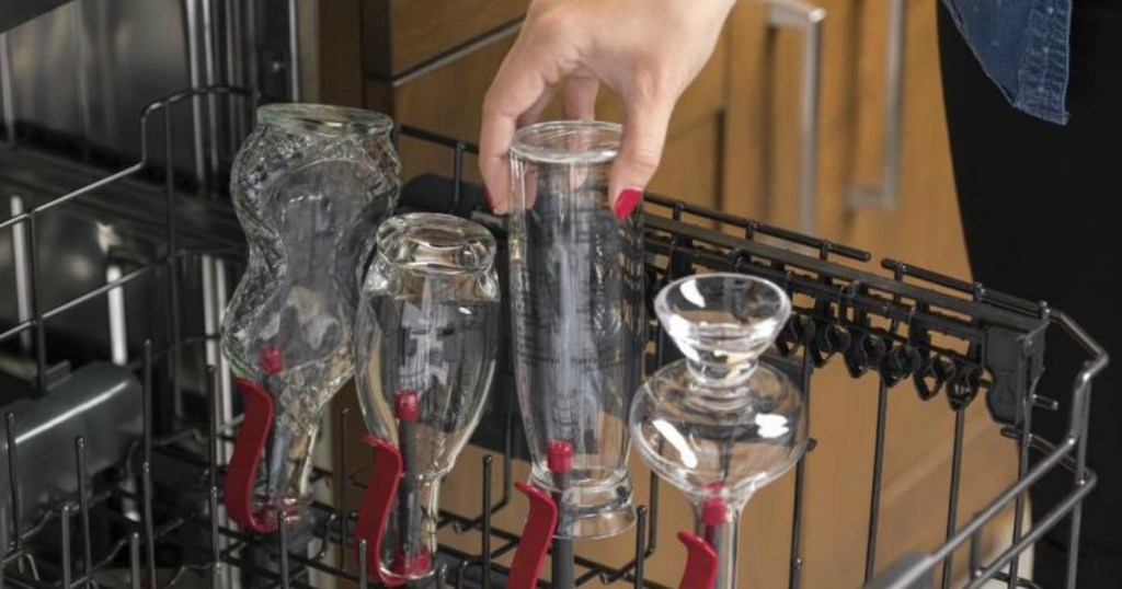 woman putting bottles in dishwasher