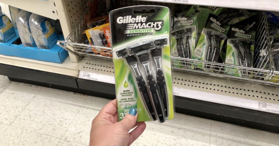 woman holding gillette razors at store