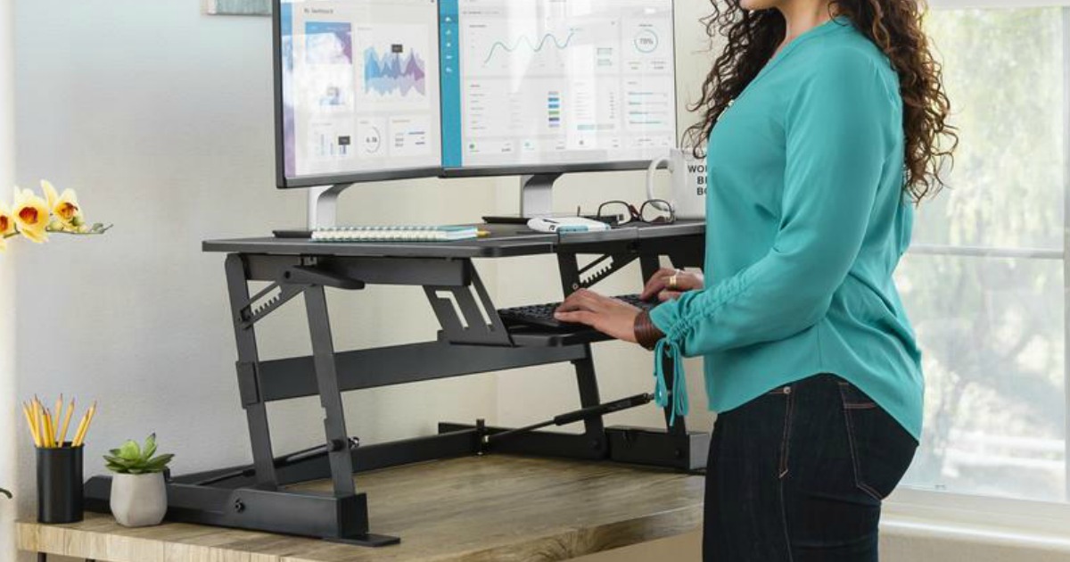 woman standing at an adjustable height standing desk