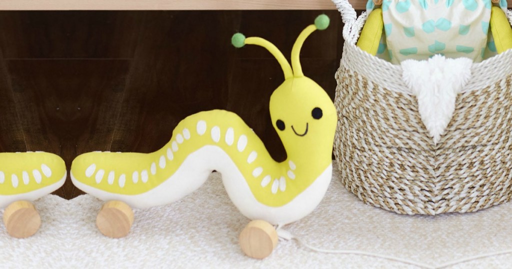 Inchworm Pull Toy in nursery next to basket
