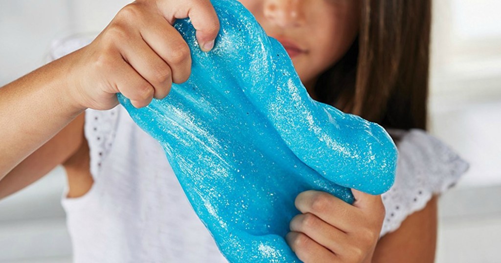 girl holding sparkling blue slime