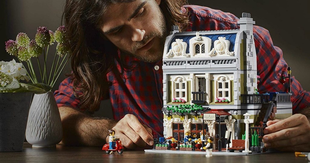 man building LEGO Parisian Set