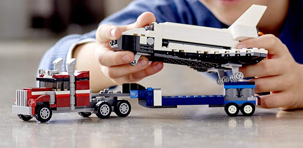 boy playing with LEGO shuttle