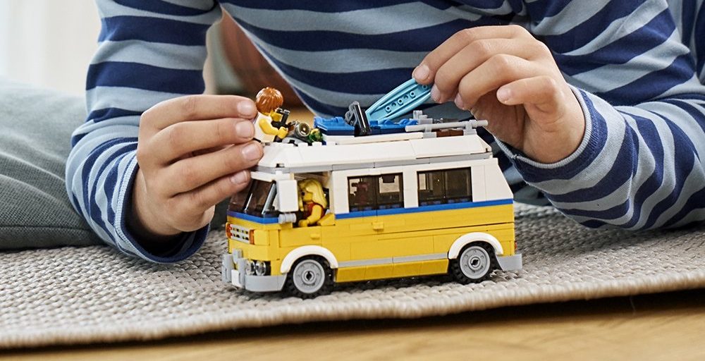 boy playing with LEGO van