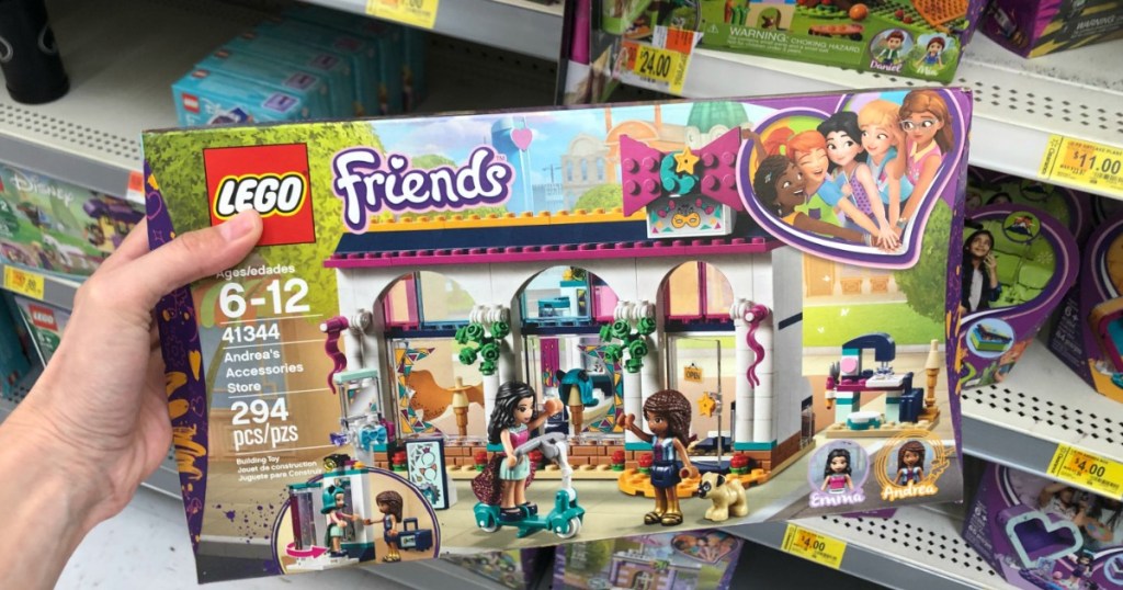 woman holding LEGO Friends Andrea's Accessories Store in Walmart store