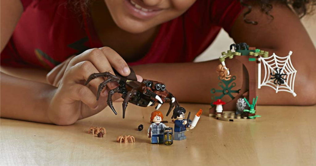LEGO Harry Potter Aragog's Lair Building Kit child holding pieces