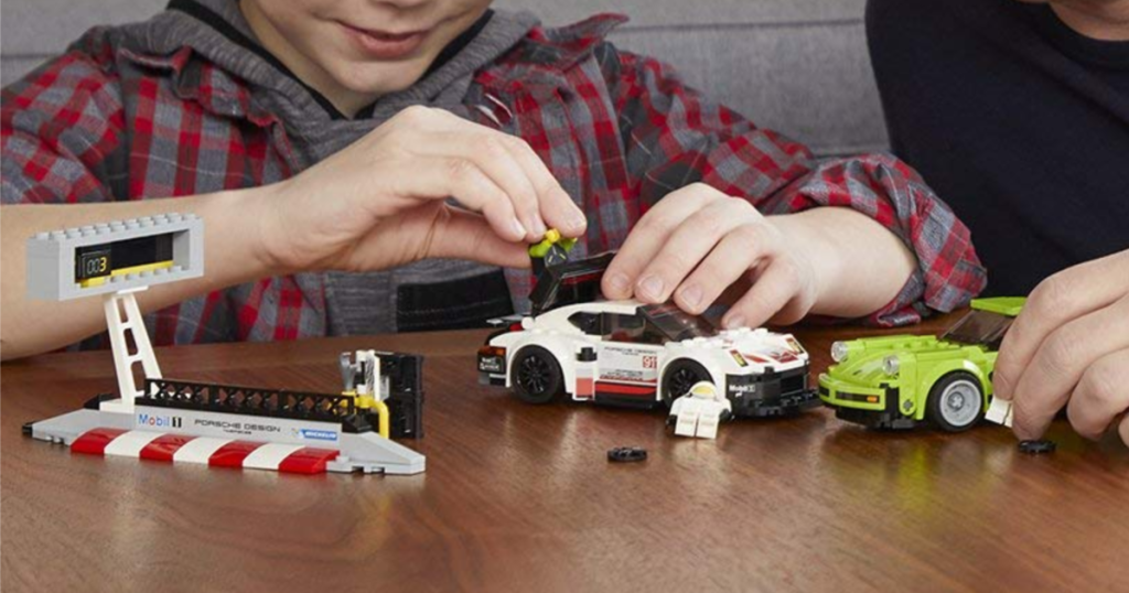 Child playing with a LEGO Speed Champions Porsche Turbo Building Kit