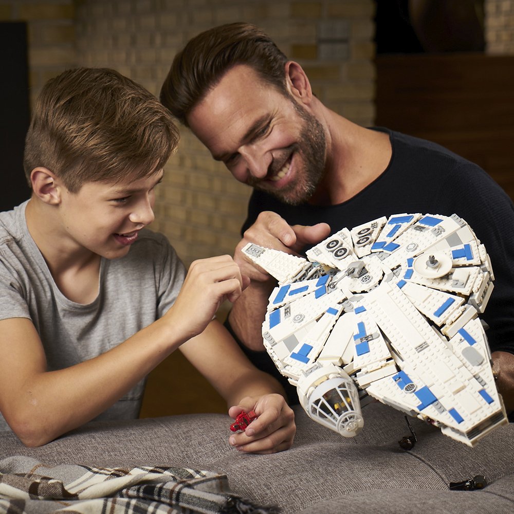 people building the LEGO Star Wars Solo- A Star Wars Story Kessel Run Millennium Falcon