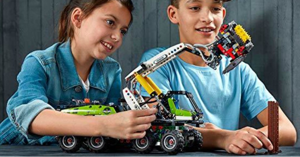 boy and girl playing with a LEGO Technic Forest Machine set