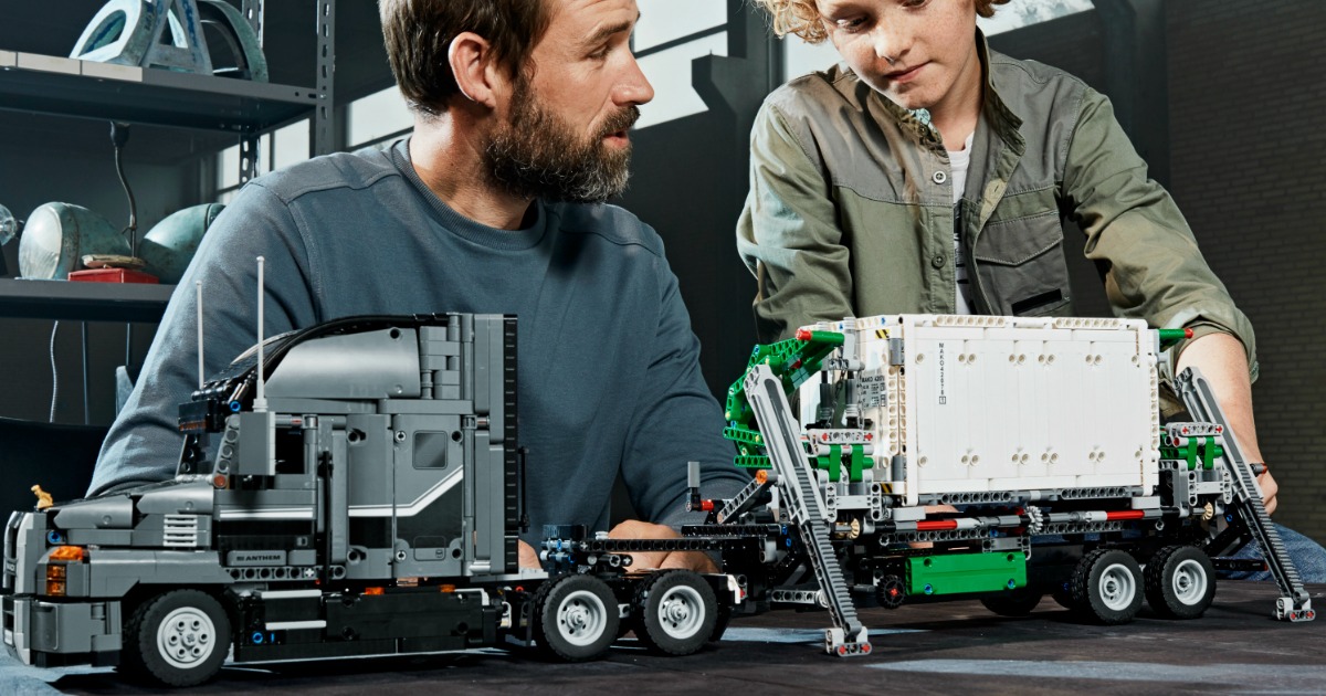 adult and child building LEGO Mack set