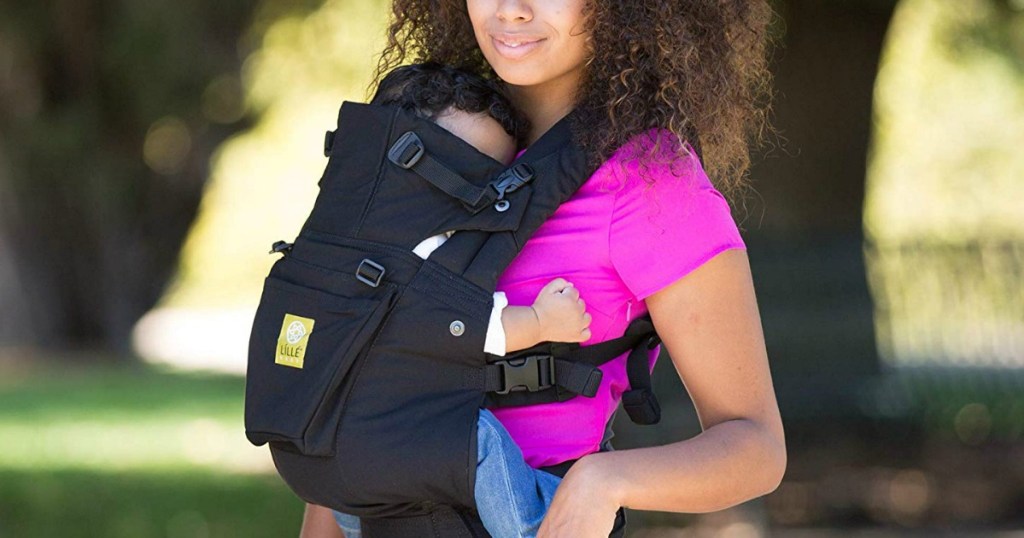 mom holding her baby in a LILLEbaby carrier