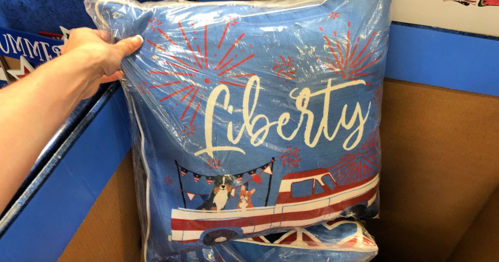 womans hand holding up liberty pillow at home depot