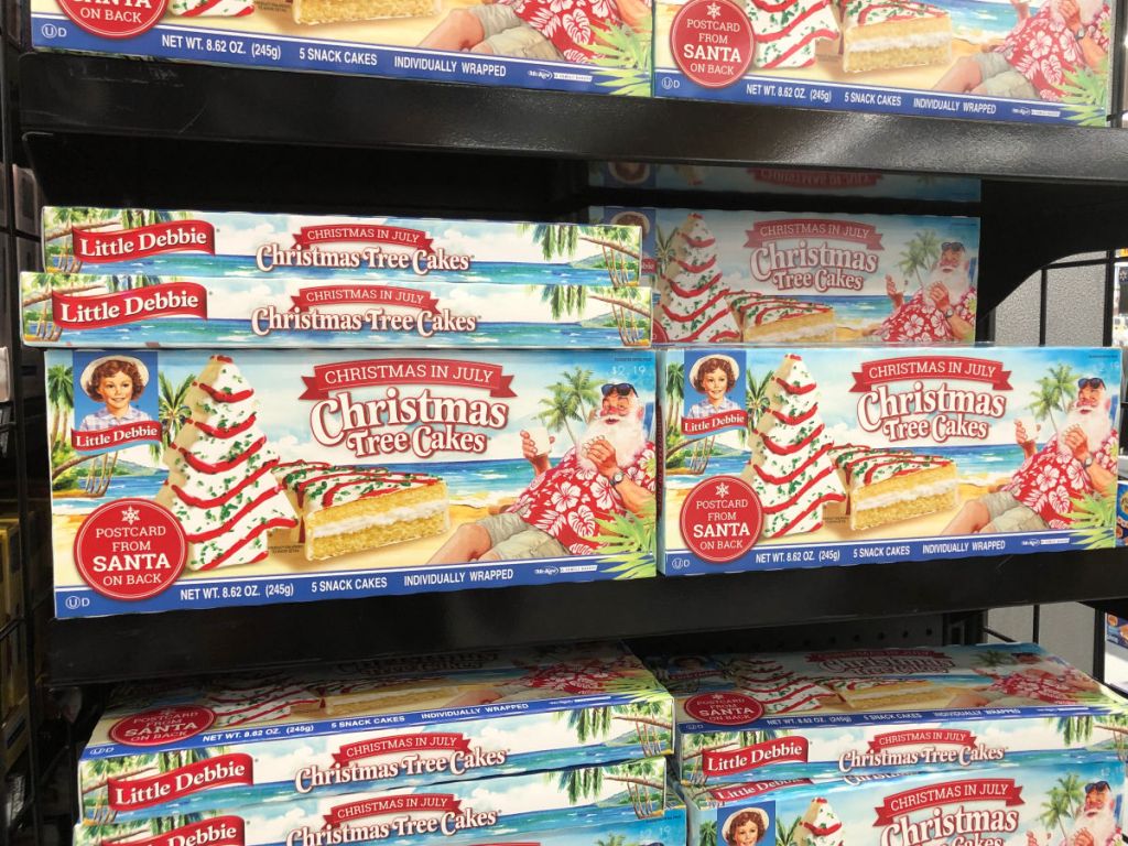 shelf display of boxes of little debbie christmas tree cakes in july