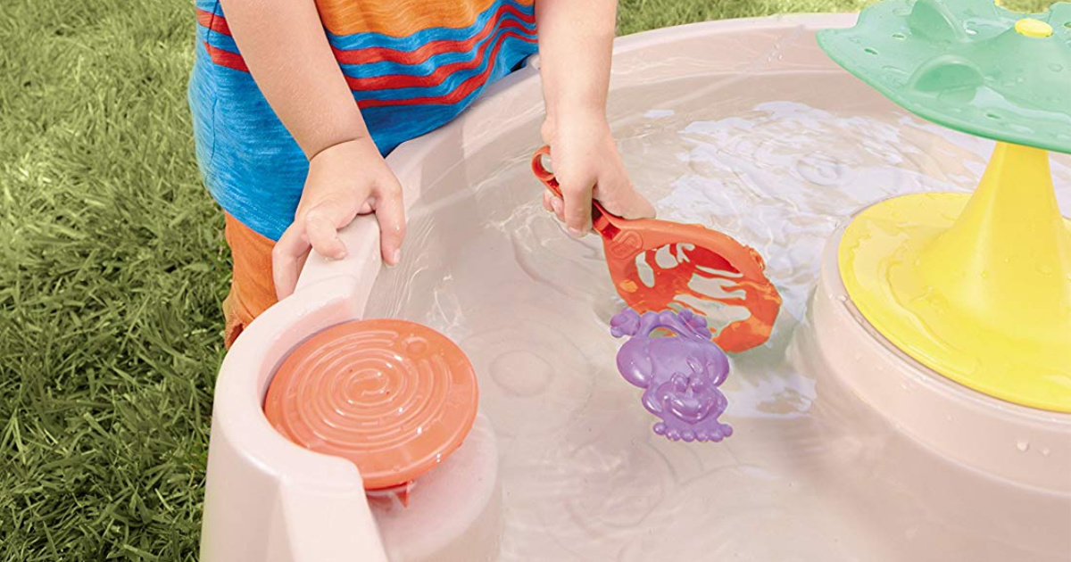 boy playing with little tikes lily pad water table