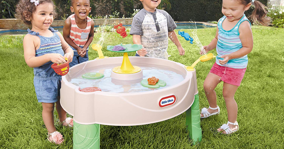 kids playing with little tikes frog pond water table