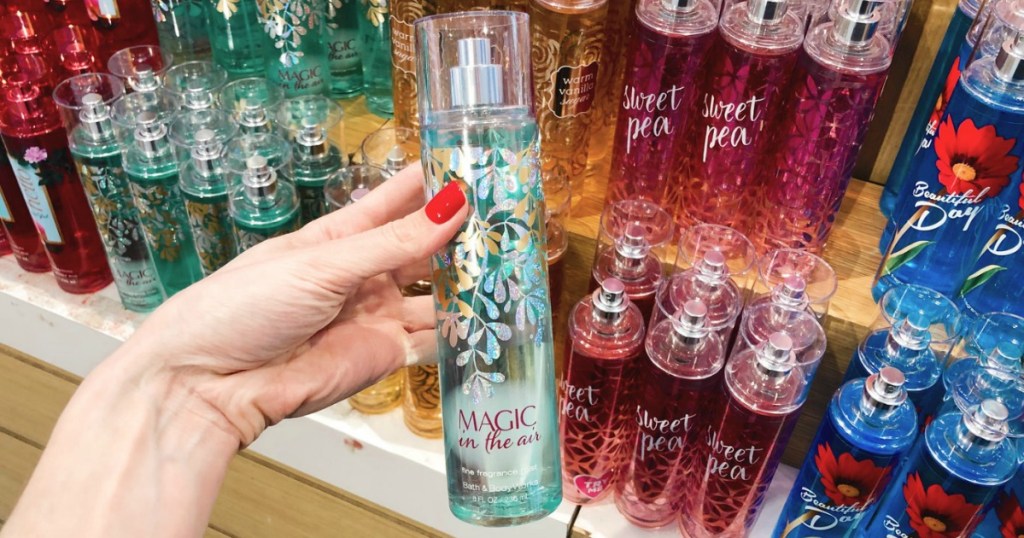 Magic in the Air scent of Bath & Body Works Fine Fragrance Mist in hand in front of in-store display